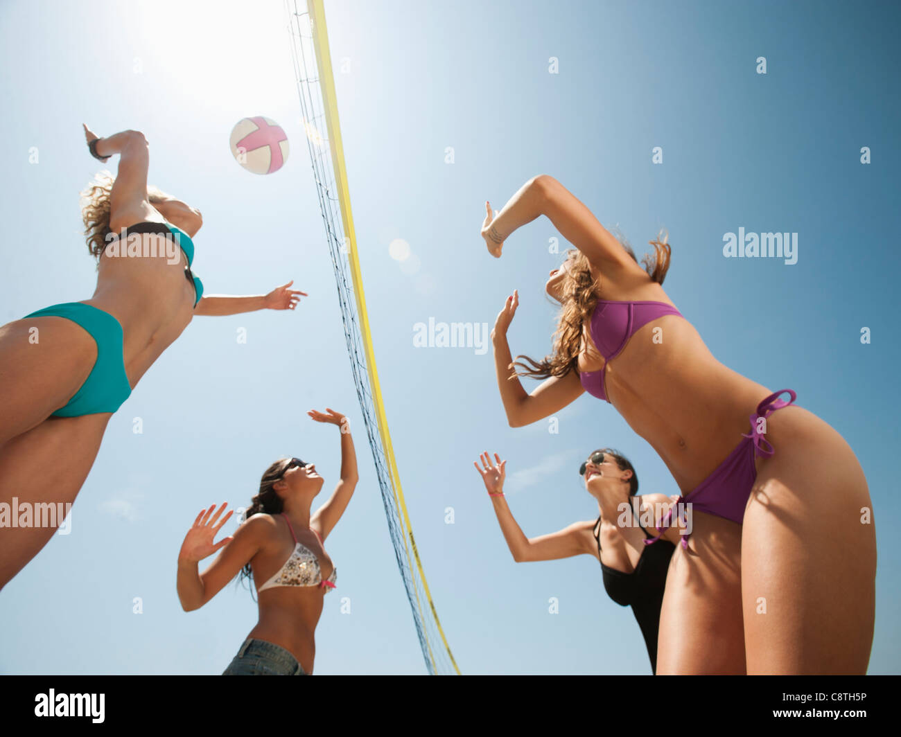 USA, California, Malibu, Group of young women playing beach volleyball Stock Photo