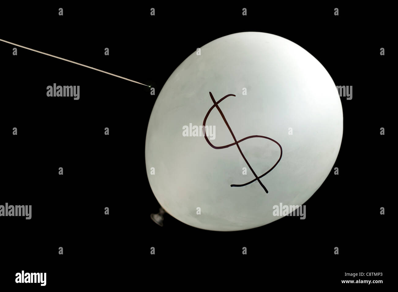 Balloon and symbol of dollars. Metaphor of financial crisis Stock Photo
