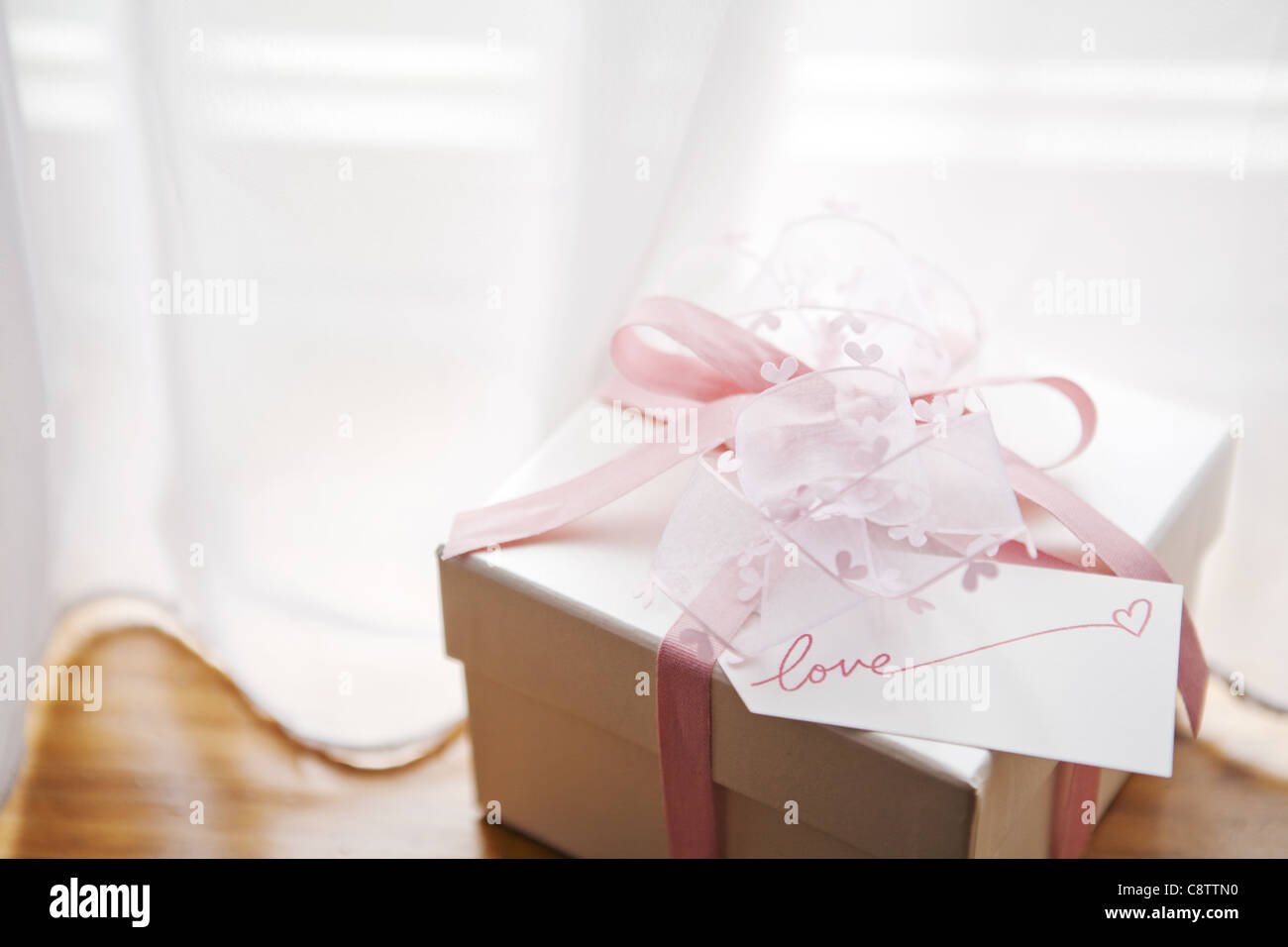 Wrapped Pink Gift Box On Table Stock Photo - Alamy