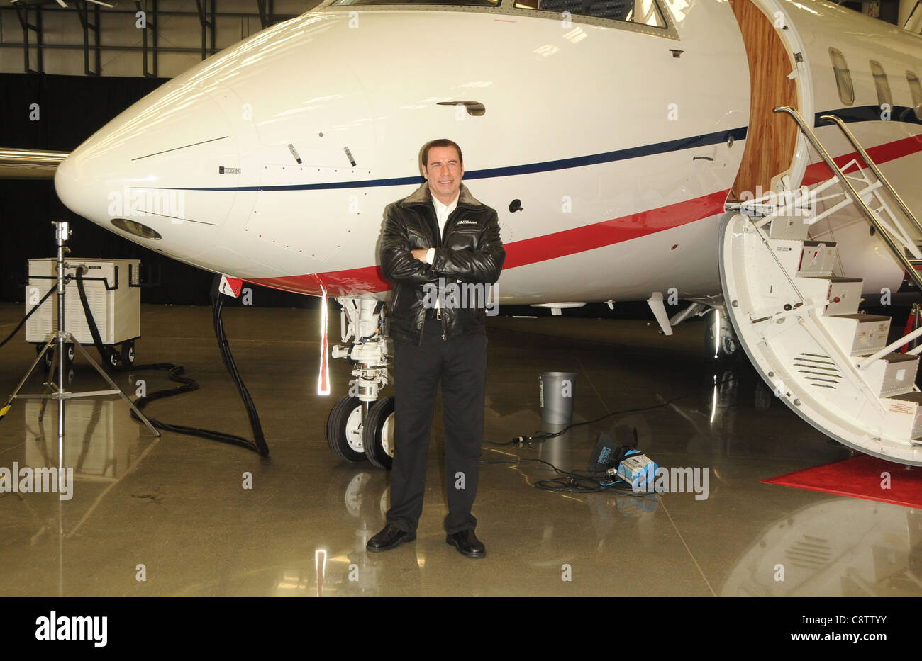 John Travolta at a public appearance for Bombardier Business Aircraft Jet Showcase, Hangar 25, Burbank, CA September 20, 2011. Stock Photo