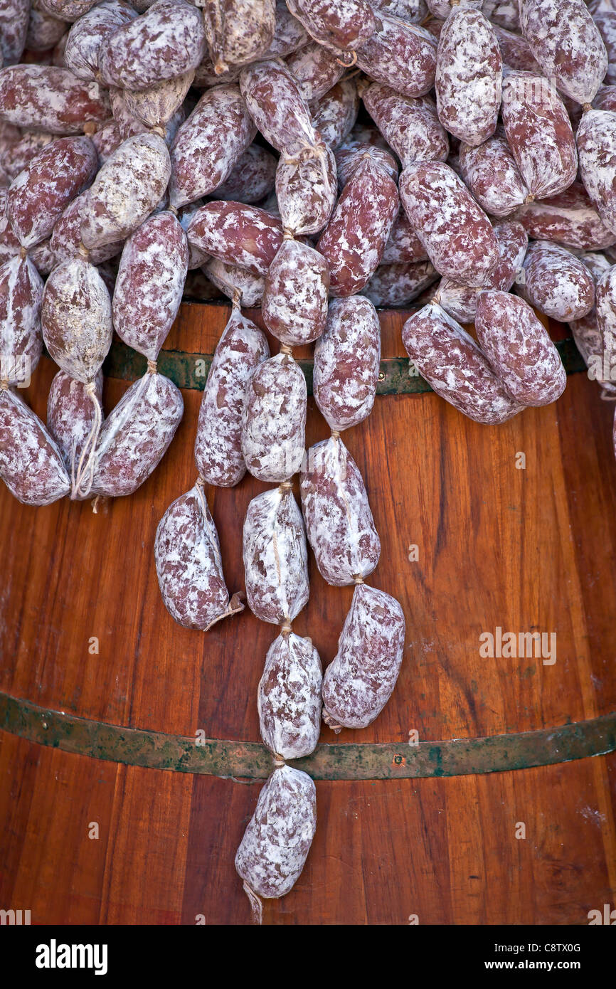 Salami sausages in a small wooden barrel at an Italian market in Cannobio Stock Photo