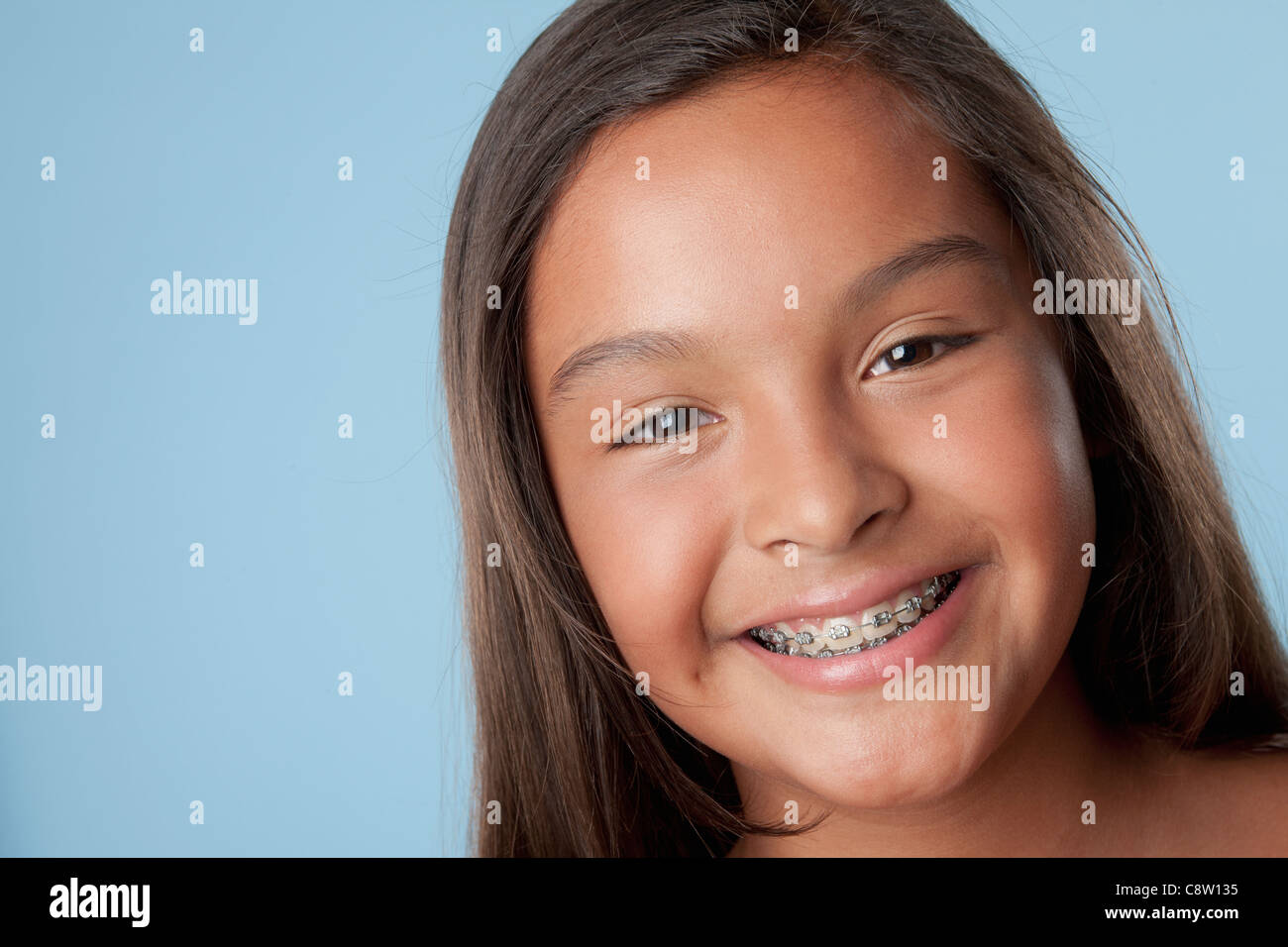 Studio portrait of girl smiling Stock Photo - Alamy