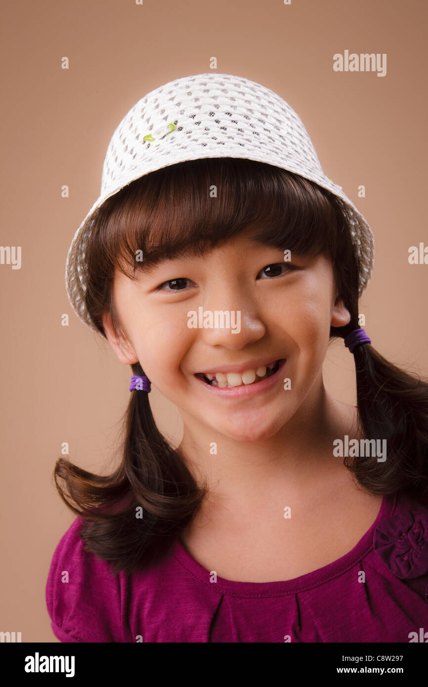 Studio portrait of girl wearing hat Stock Photo Alamy