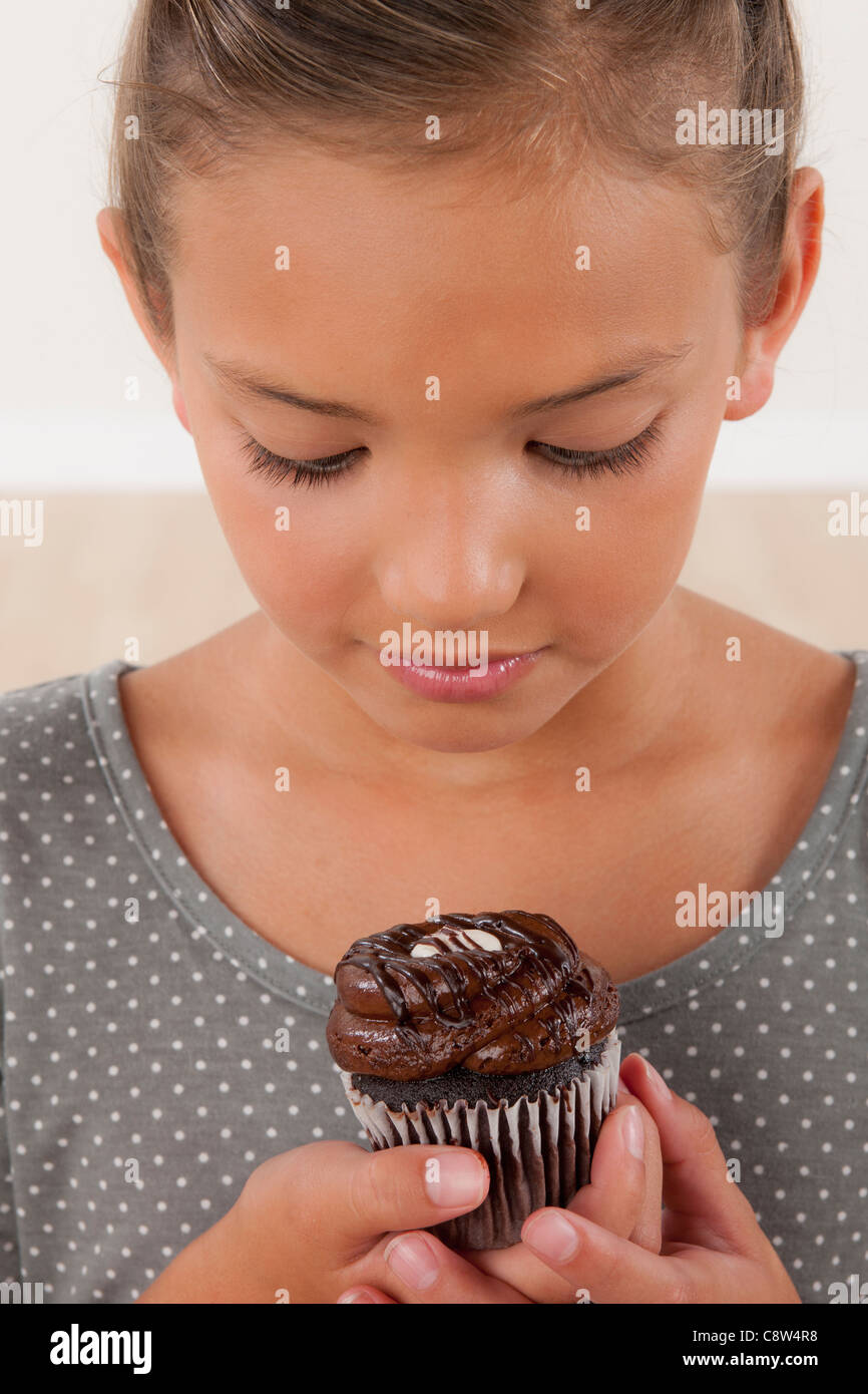 Studio portrait of girl holding cake Stock Photo Alamy