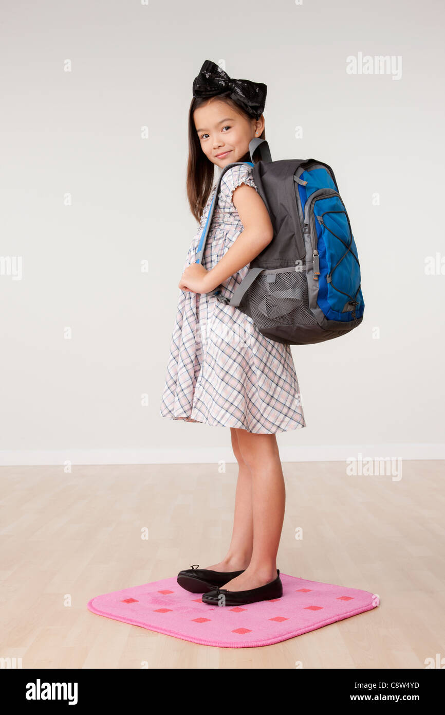 Studio portrait of girl carrying backpack Stock Photo