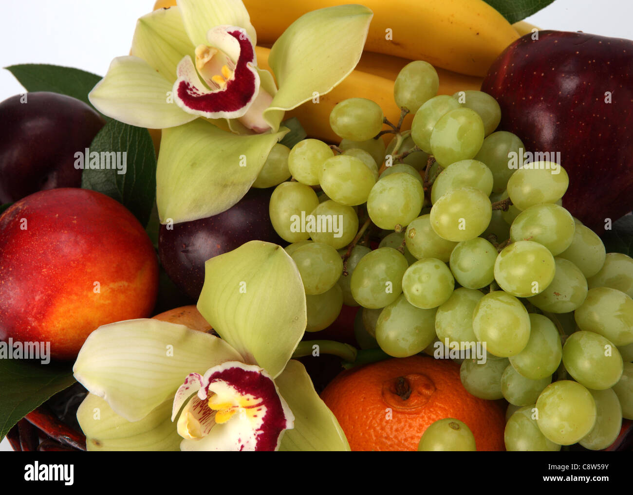 A close-up of a colorful bouquet of fruit and flowers. Stock Photo