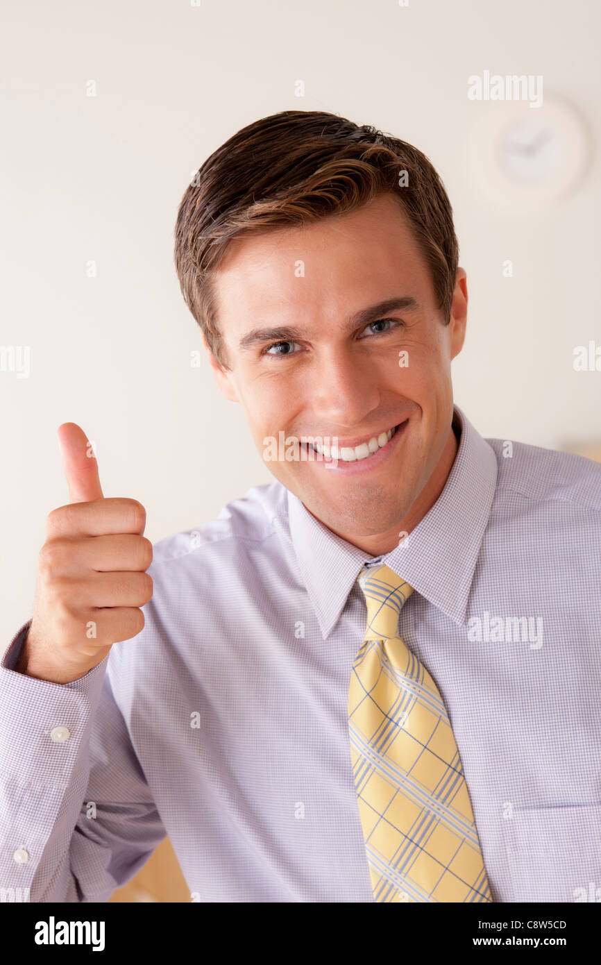 Portrait of businessman with thumbs up Stock Photo - Alamy