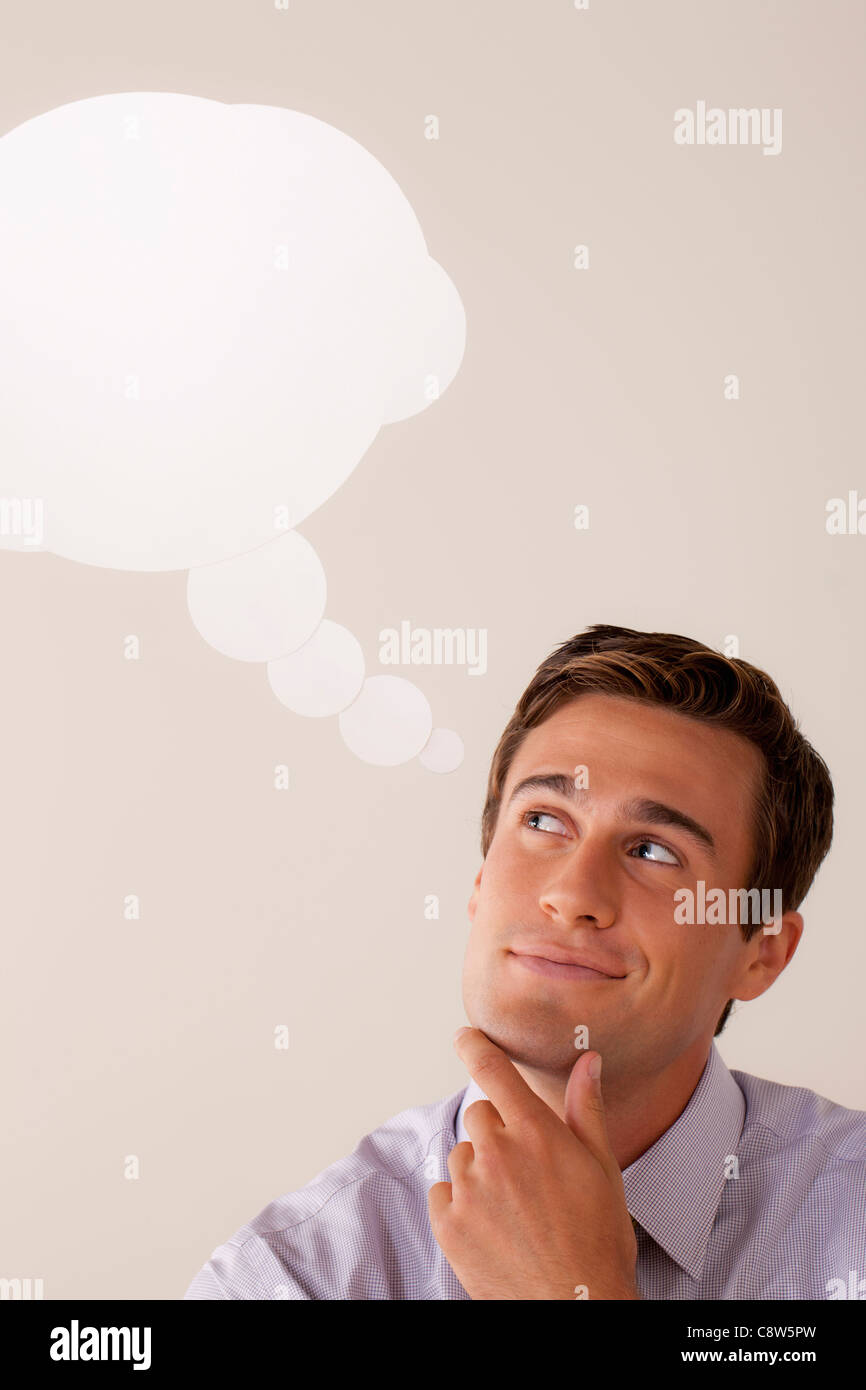 Studio portrait of businessman with thought bubble Stock Photo