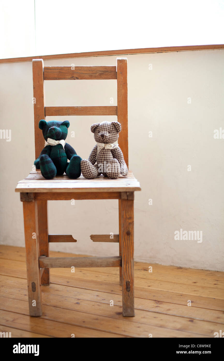 Two Soft Teddy Bear Sitting On Chair Stock Photo