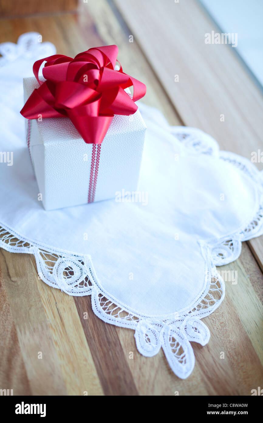 Wrapped Christmas Gift Box With Red Ribbon Stock Photo - Alamy