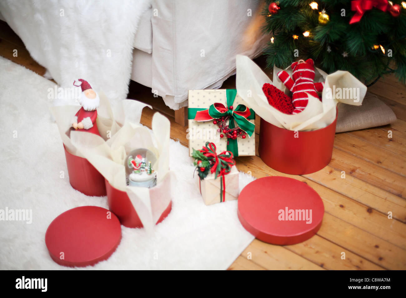 Room Interior With Unwrapped Christmas Gift Boxes And Christmas Tree Stock Photo