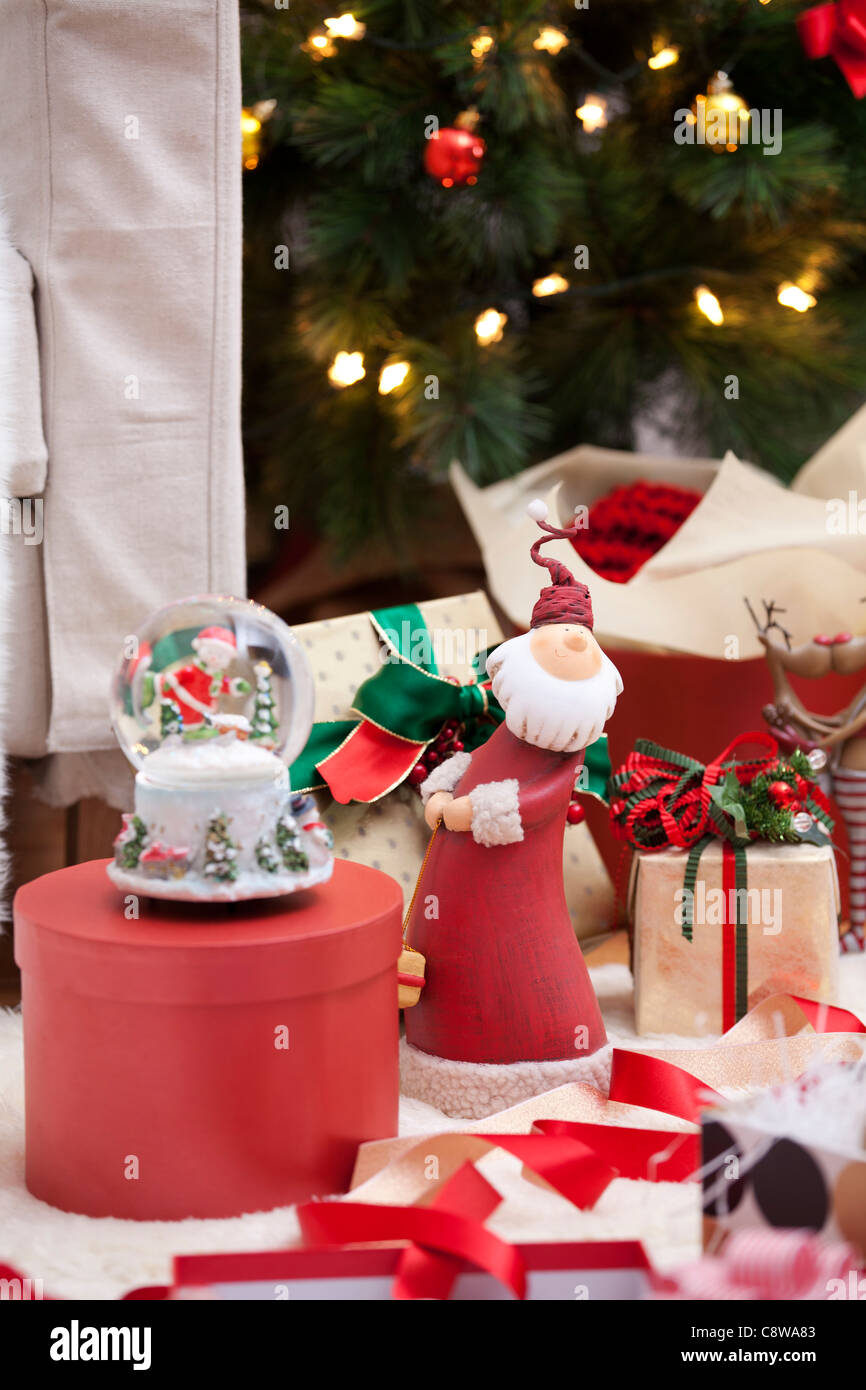 Christmas Snow Globe And Toys From Unwrapped Gift Boxes Stock Photo