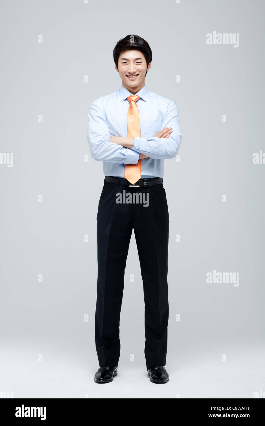 Portrait Of Smiling Asian Businessman With Arm Crossed Stock Photo - Alamy