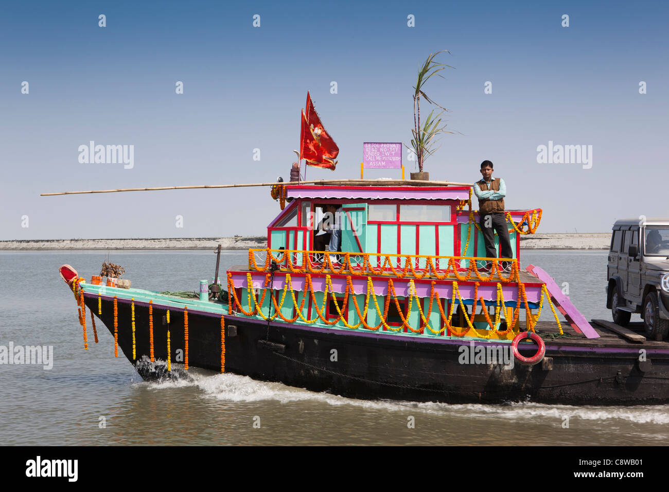 India, Assam, Sibsagarh, decorated ferry carrying 4x4 car across Brahmaputra River Stock Photo