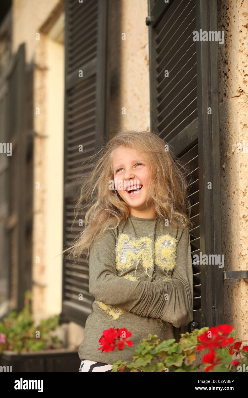 baby girl blond smiles with a happy face Stock Photo