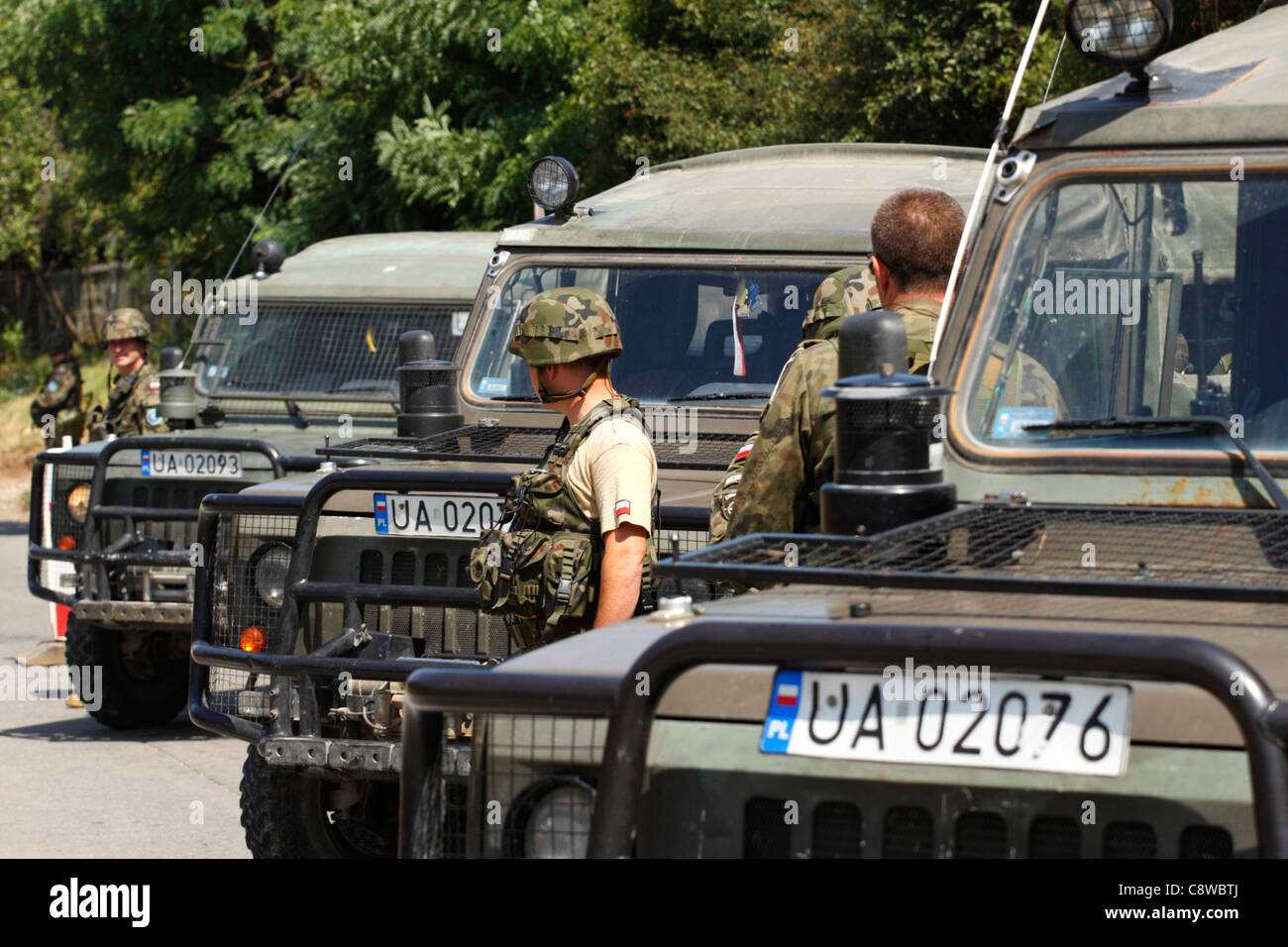 Polish KFOR soldiers with ATVs setting up a road block in Kosovo Stock Photo