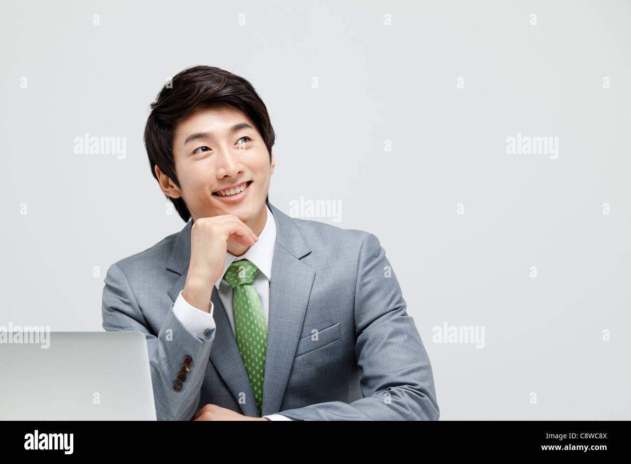 Portrait Of Smiling Asian Businessman With Laptop Stock Photo - Alamy