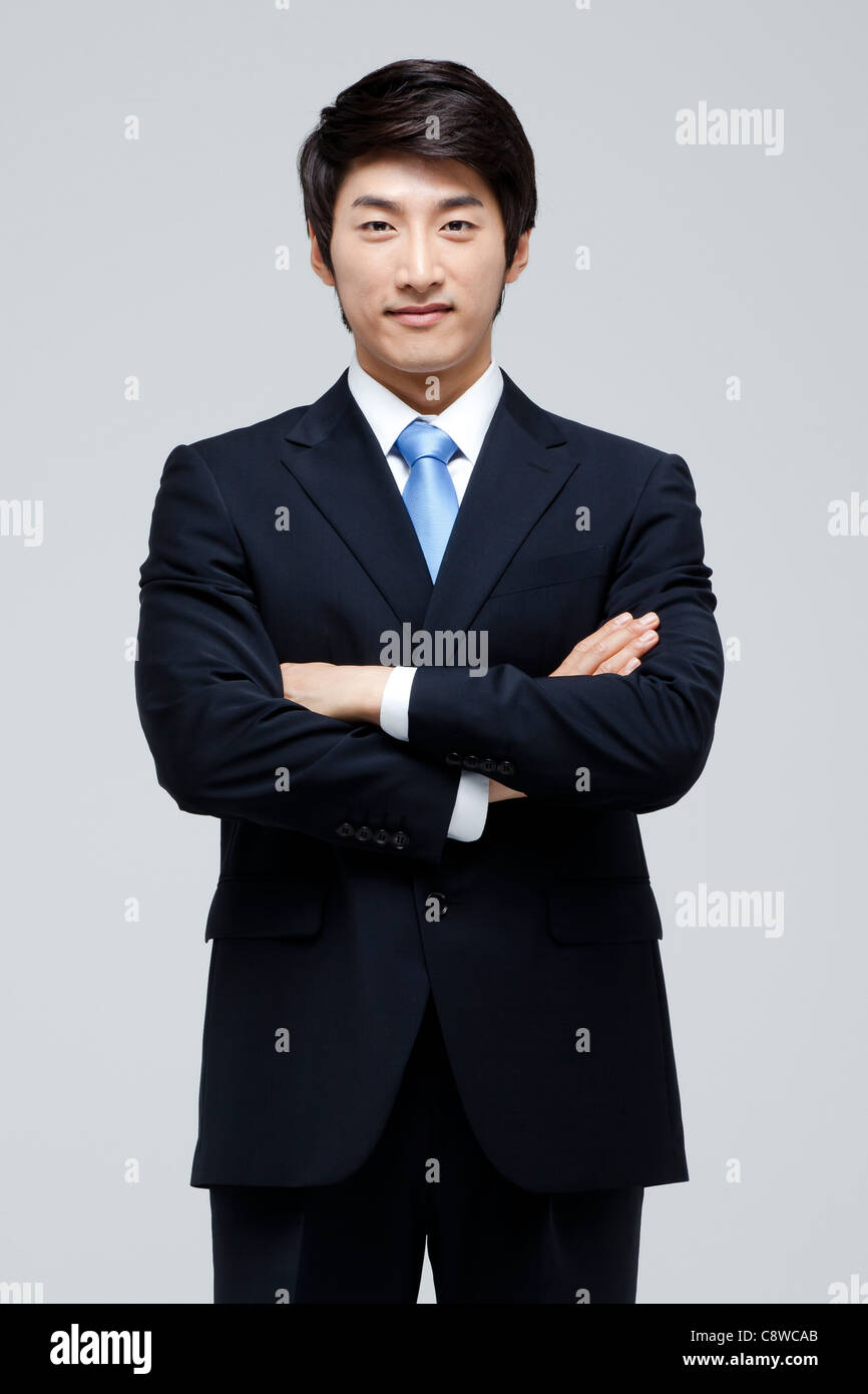Portrait Of Smiling Asian Businessman With Arm Crossed Stock Photo - Alamy