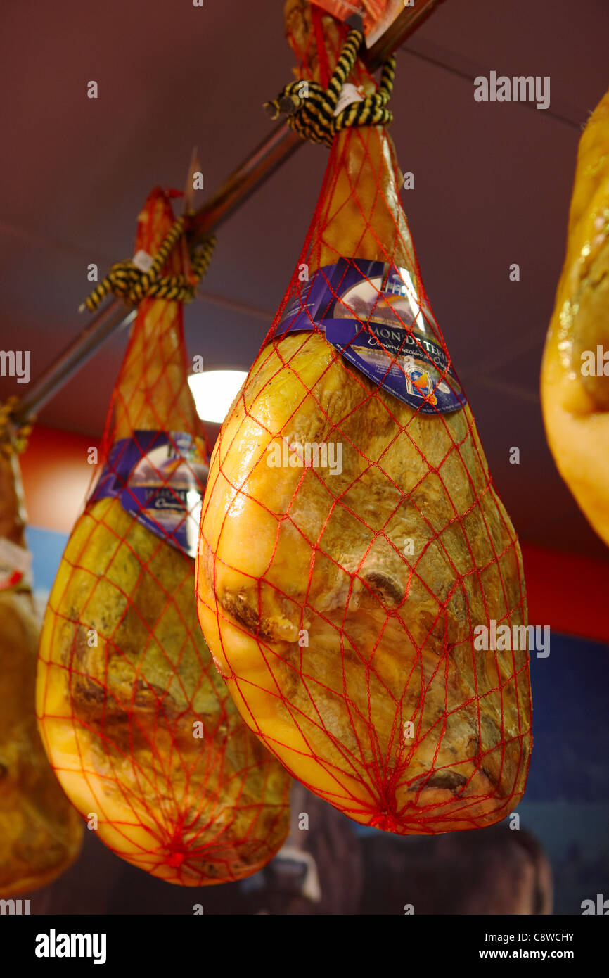 A selection of Jamon, Spanish dry-cured ham displayed for sale in a meat shop. Salou, Catalonia, Spain. Stock Photo