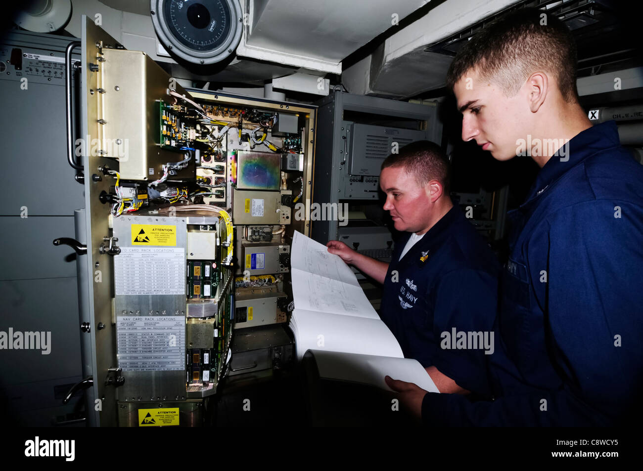 troubleshoot critical systems in the forward internal communications compartment Stock Photo