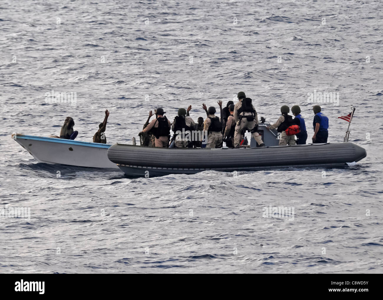 Visit, board, search and seizure team members (VBSS) in a rigid-hulled inflatable boat (RHIB) Stock Photo