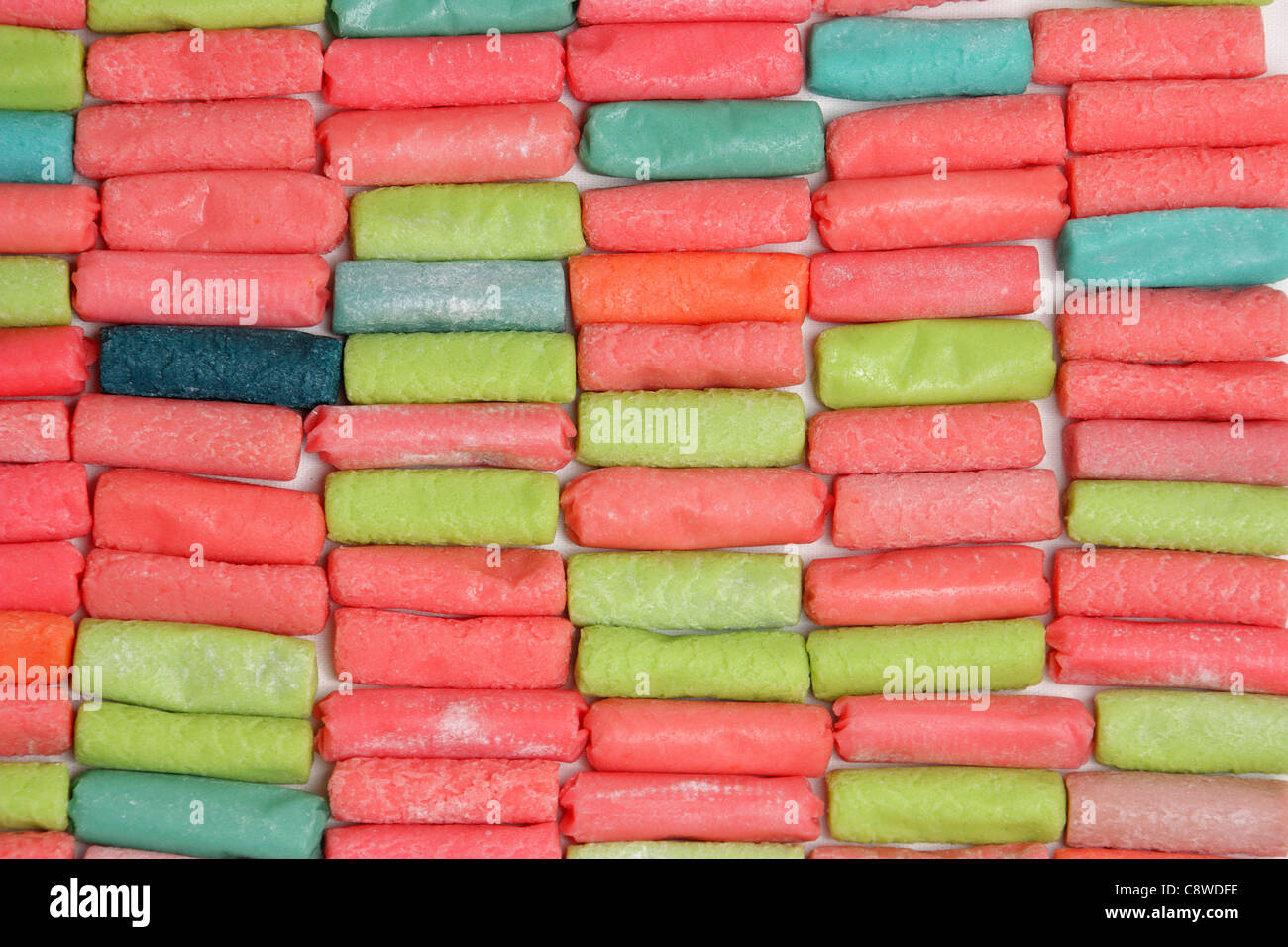 background composed of different colored chewy candies on white Stock Photo