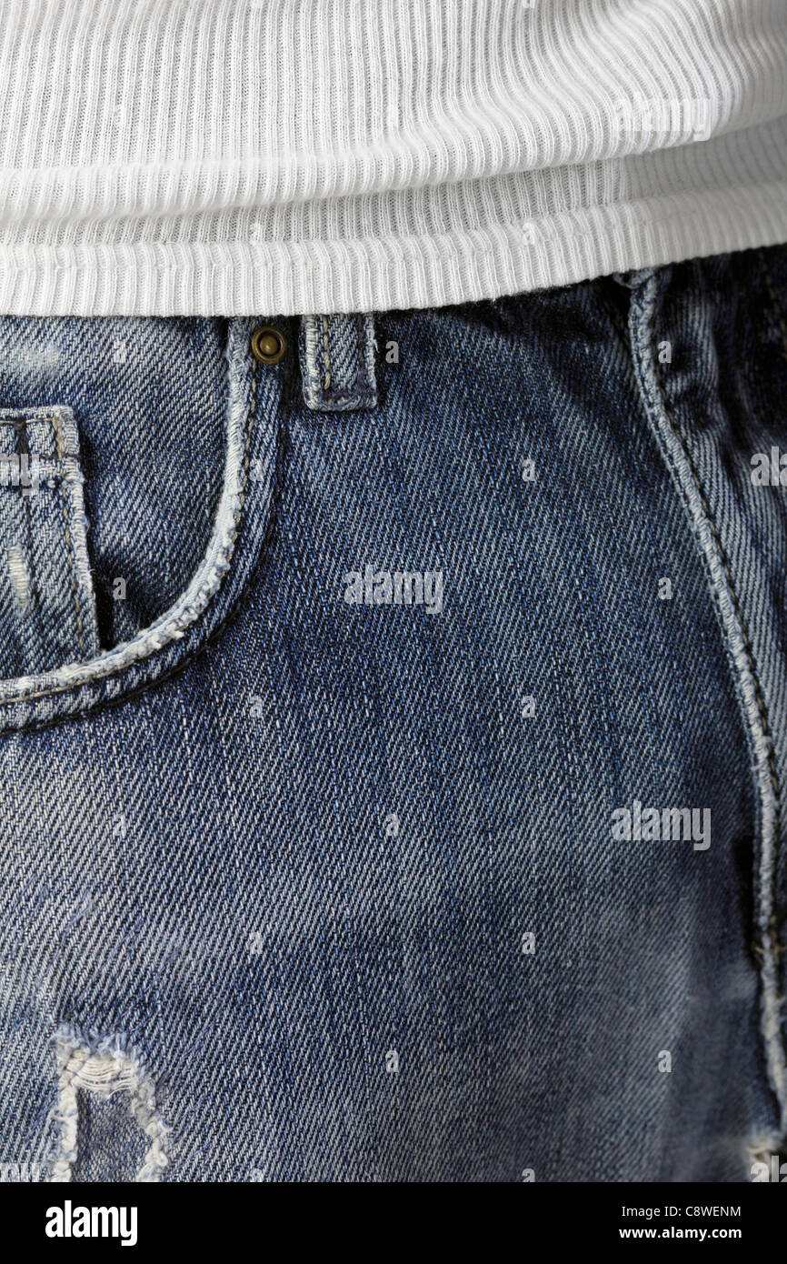 Worn blue jeans and white T-shirt as close-up. Stock Photo