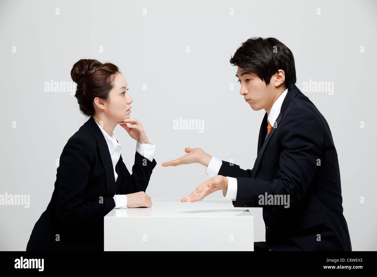 Asian Businesswoman And Businessman Having A Face To Face Discussion Stock Photo