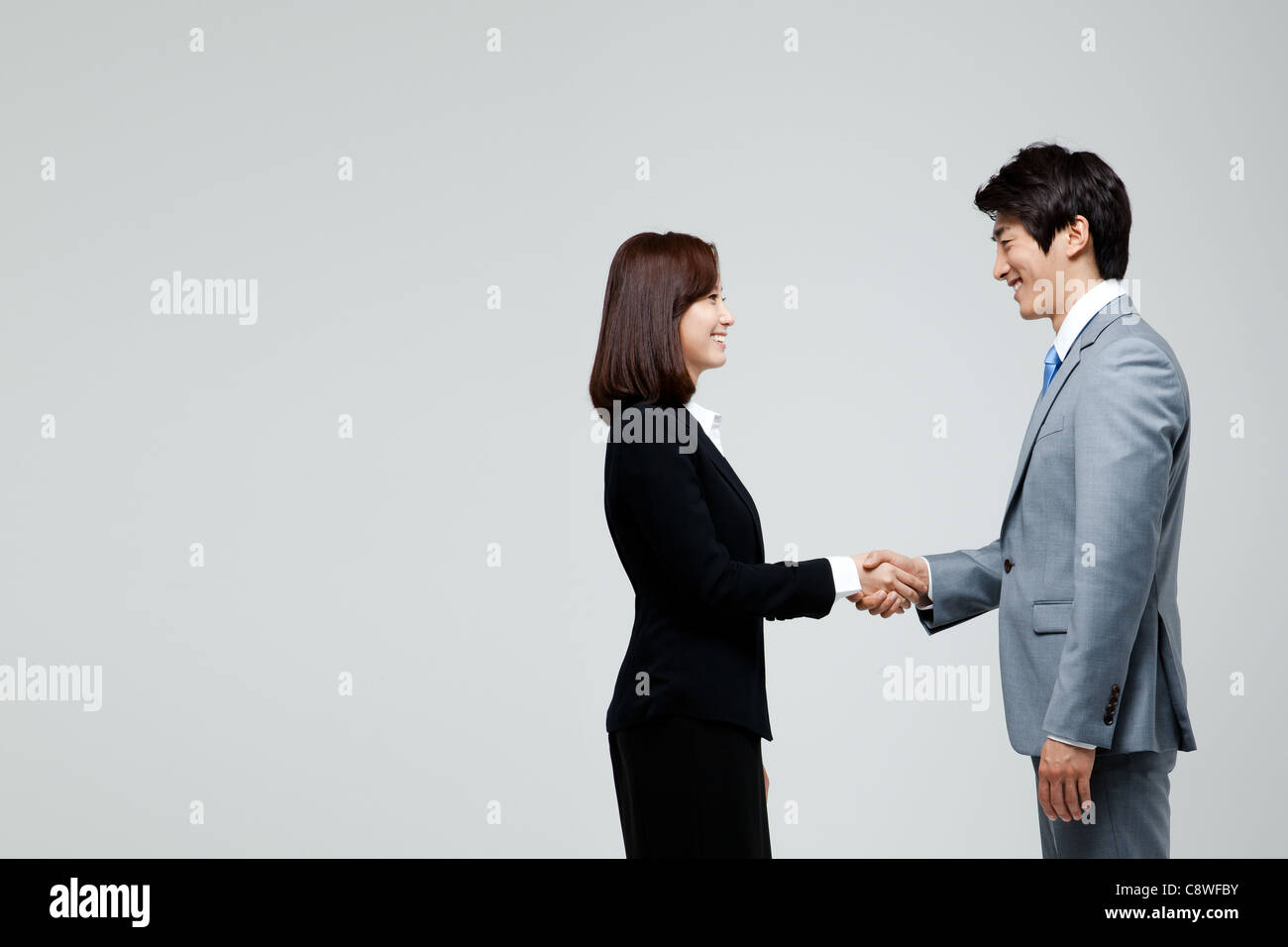 Asian Businesswoman And Businessman Shaking Hand Stock Photo