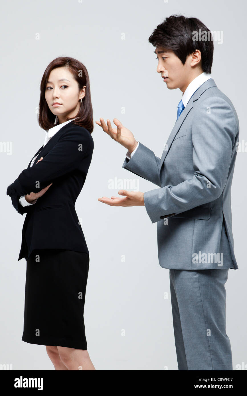 Asian Businesswoman And Businessman Having A Discussion Stock Photo