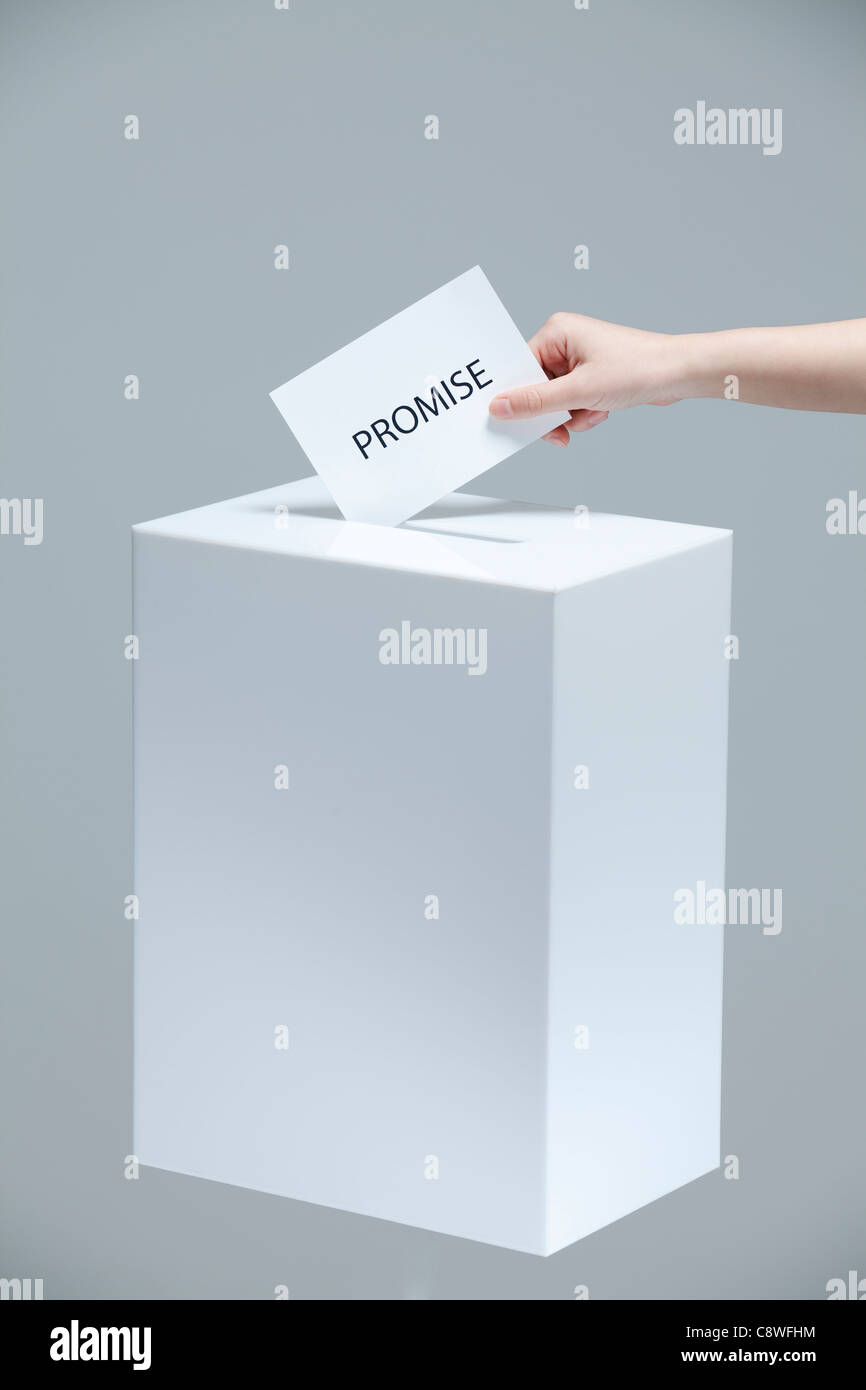 Woman Inserting Voting Paper Into Ballot Box Stock Photo