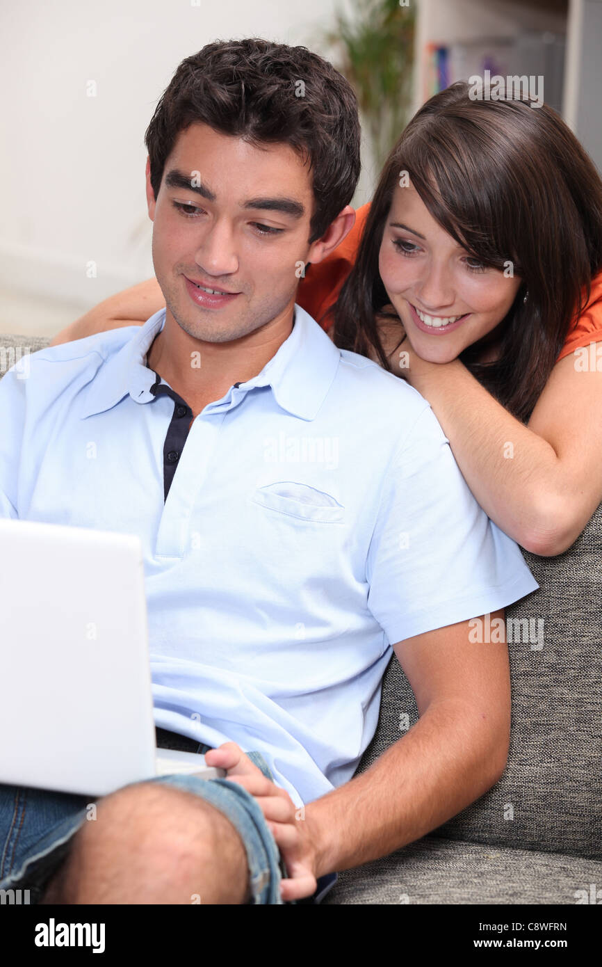 Couple at home with laptop Stock Photo - Alamy
