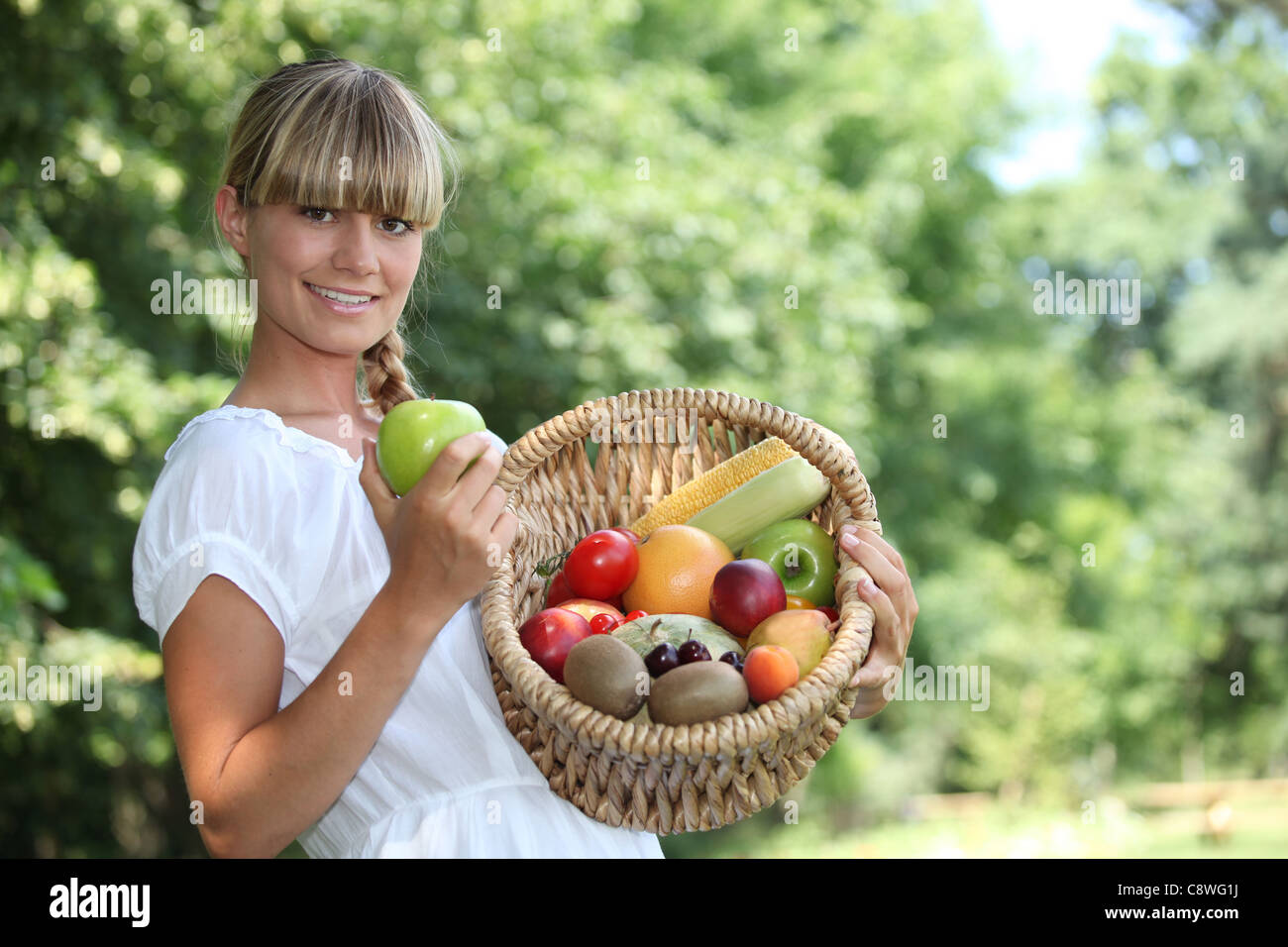 Woman with fruit basket Stock Photo - Alamy