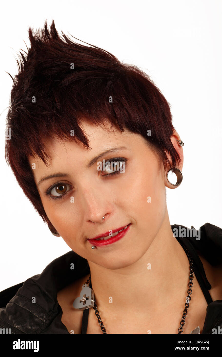 young woman with facial piercings ear plug rings and short cropped spiky hair Stock Photo