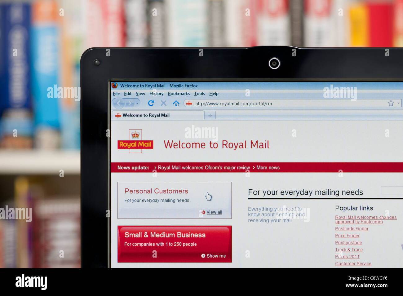 The Royal Mail website shot against a bookcase background (Editorial use only: ­print, TV, e-book and editorial website). Stock Photo