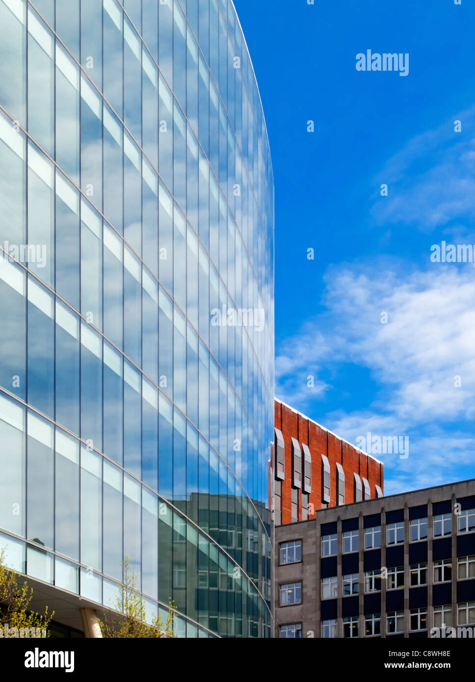 Modern glass tower block next to older office building in Spinningfields area of central