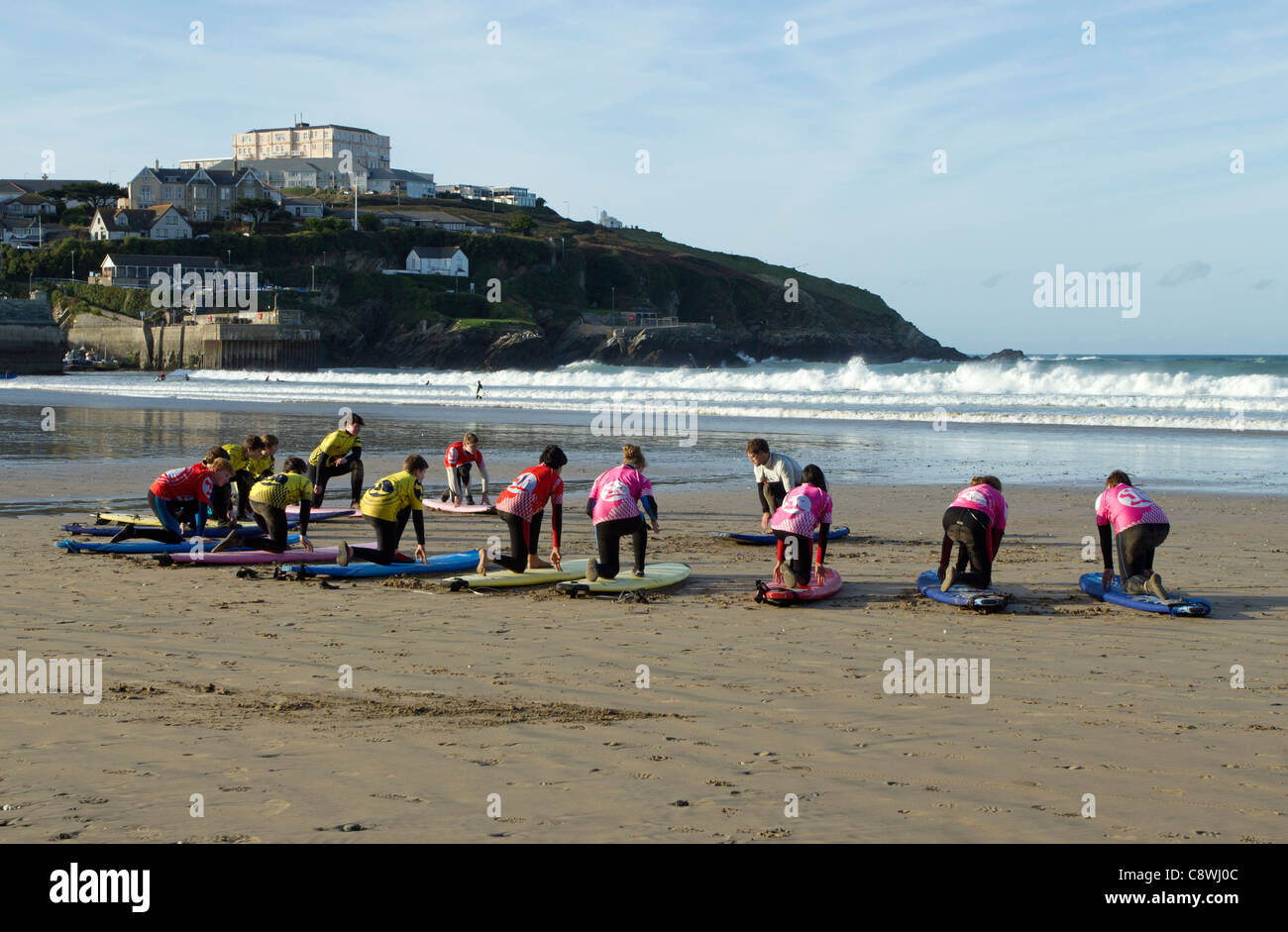Children being given a surfing lesson in surf school, Newquay Cornwall