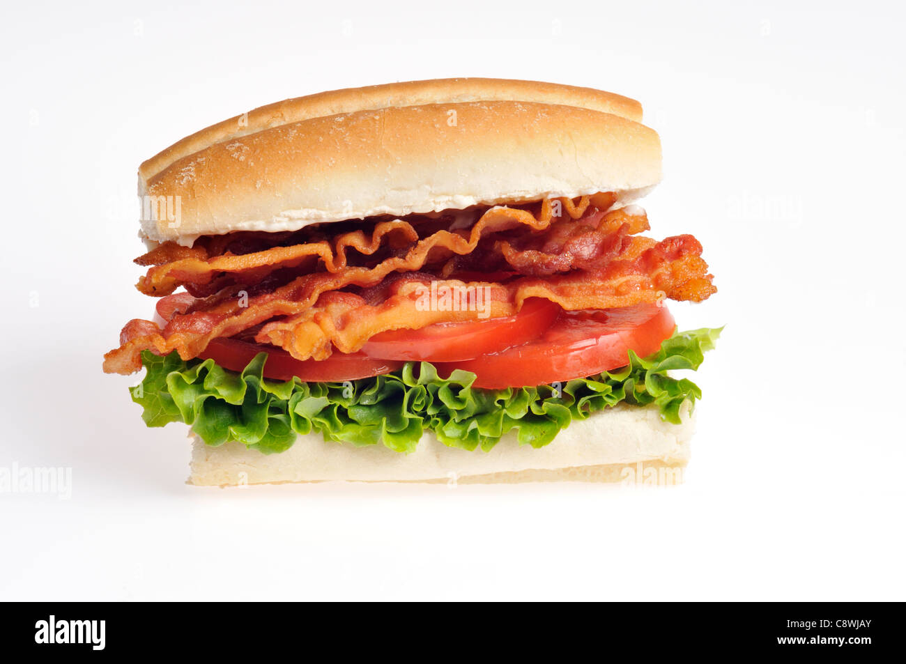 Bacon Lettuce and Tomato BLT sandwich in a roll on white background cutout. Stock Photo