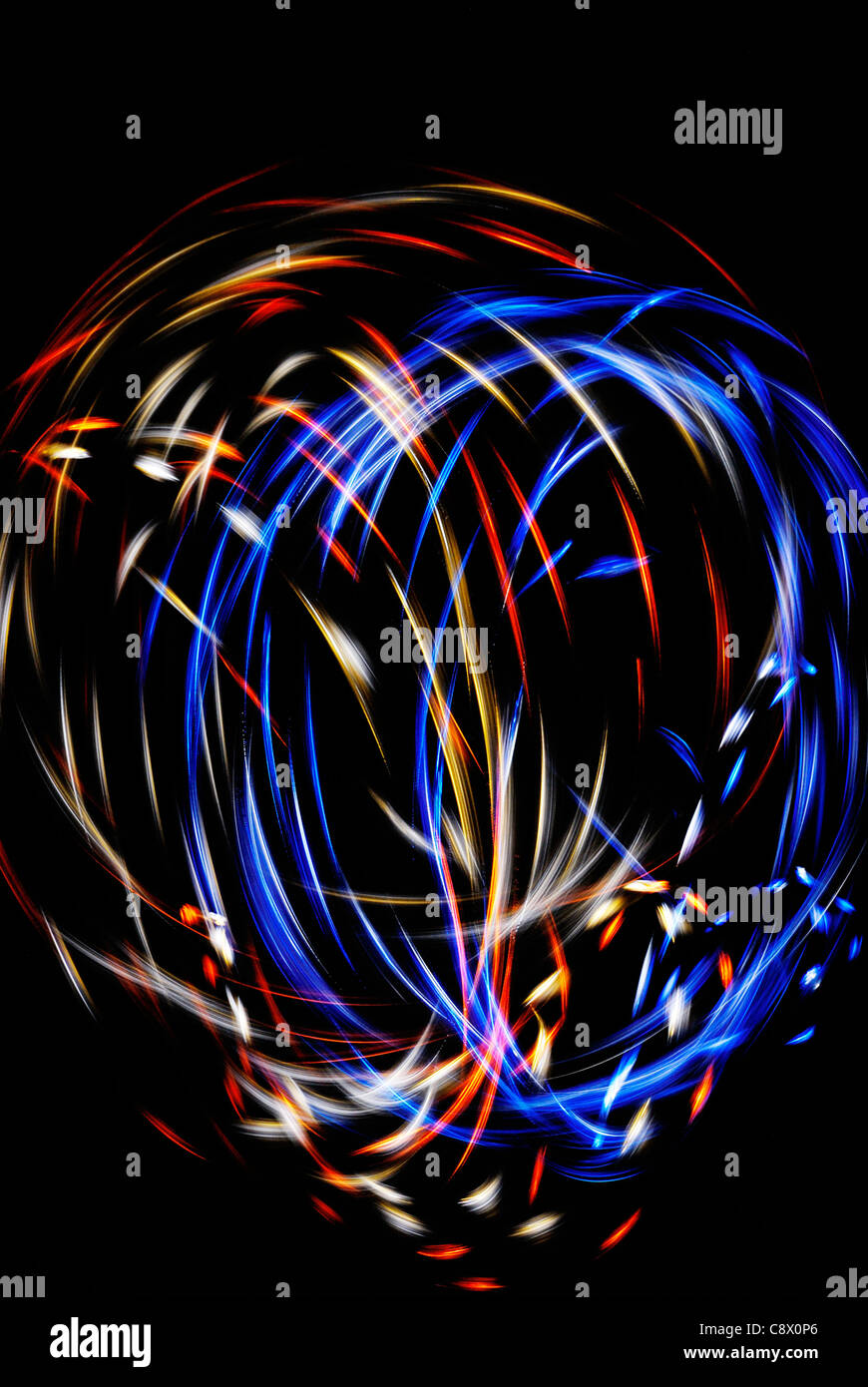 Glowstringing - Light patterns created by twirling Poi at night - LED glowsticks on strings. Stock Photo