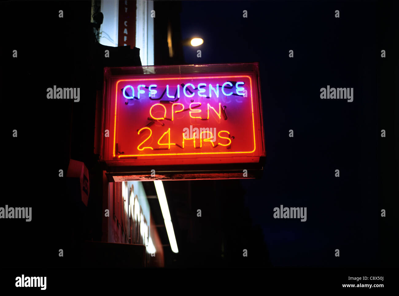 Shop sign advertising Off Licence 'Open 24 hours', Brighton. Stock Photo