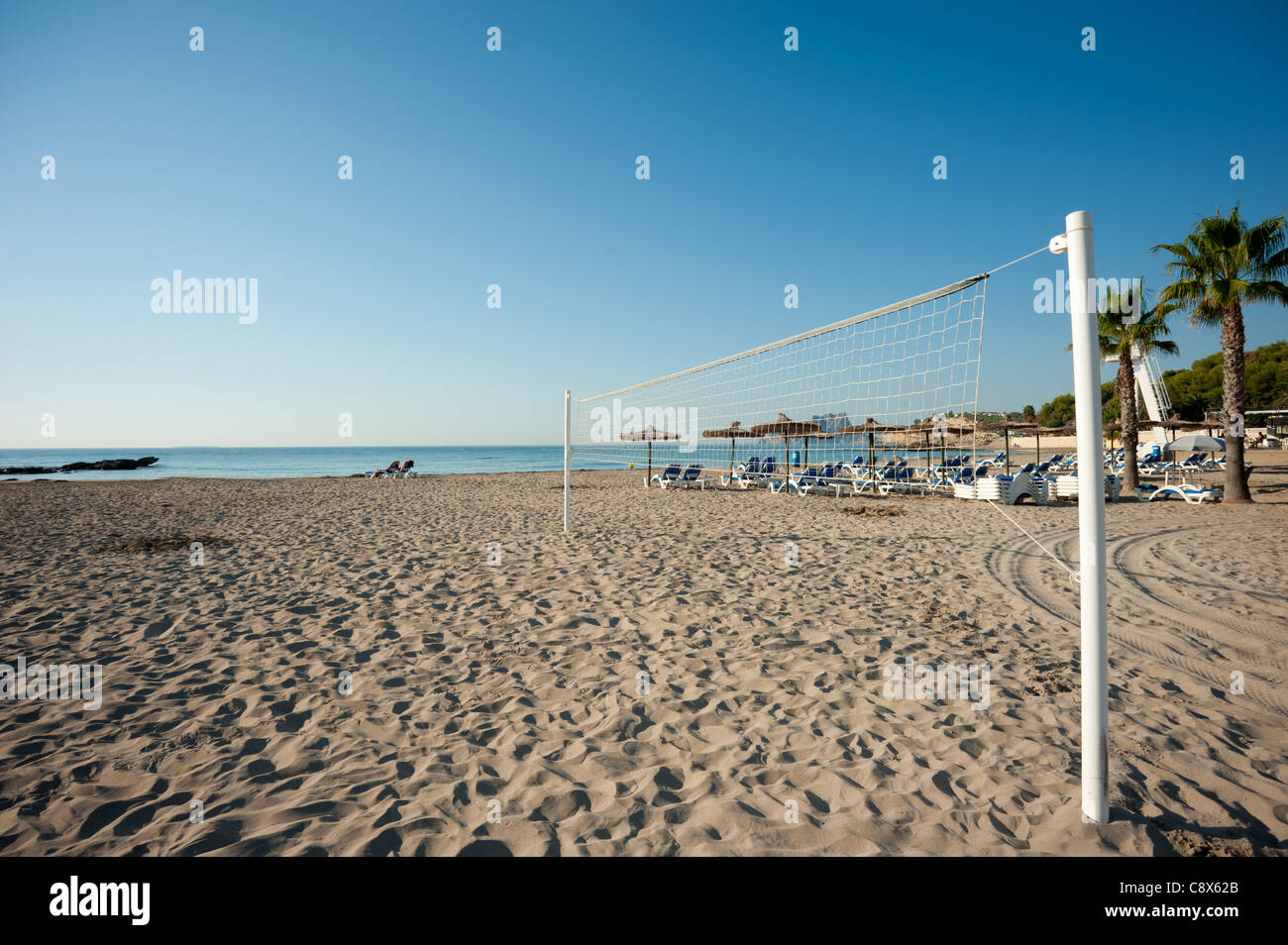 Beach volley net on a calm sunny resort beach Stock Photo