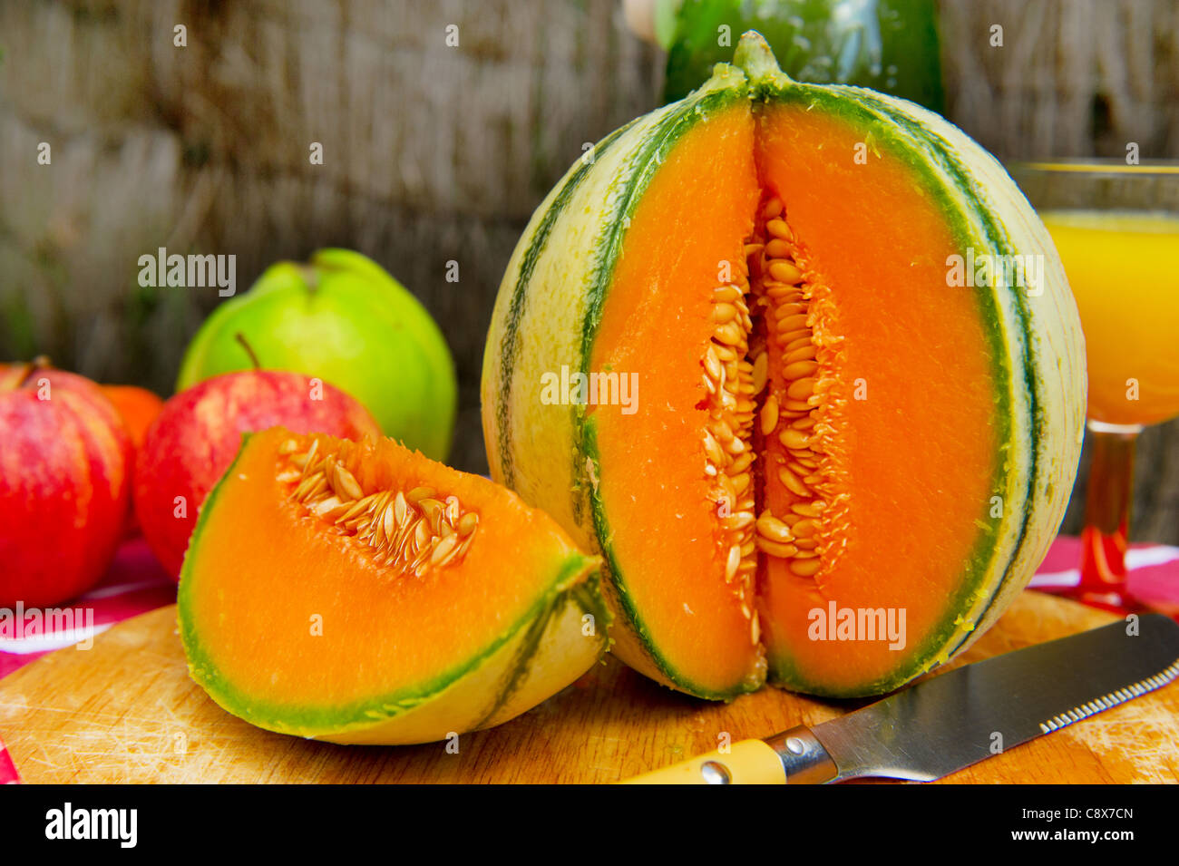 Fruit still life with cut melon and apples Stock Photo Alamy