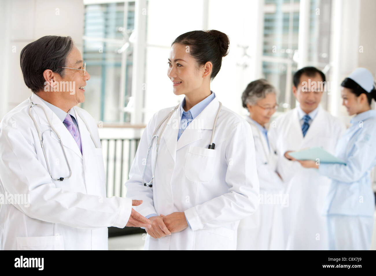 Doctors and and a Nurse in a Hospital Corridor in Discussion Stock ...