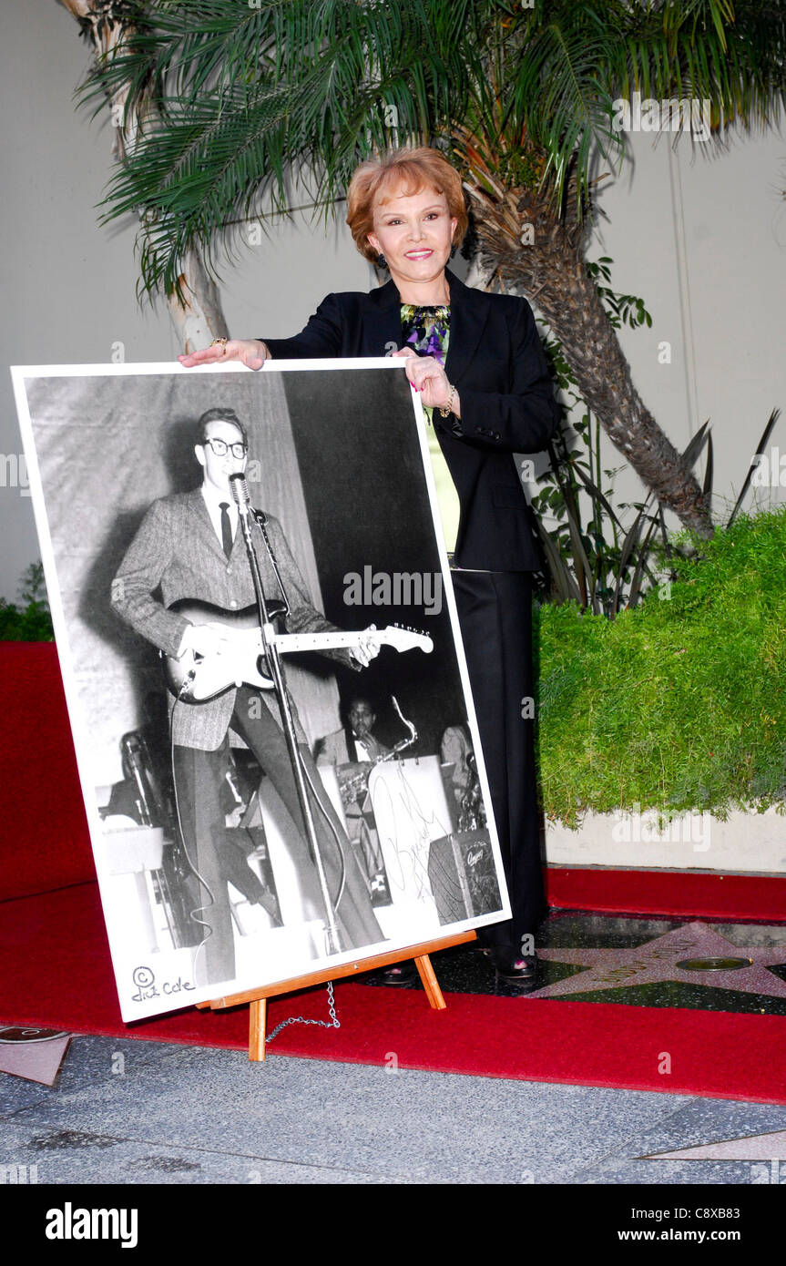 Maria Elena Holly (with picture of Buddy Holly) at the induction ceremony for Star on the Hollywood Walk of Fame Ceremony for Stock Photo