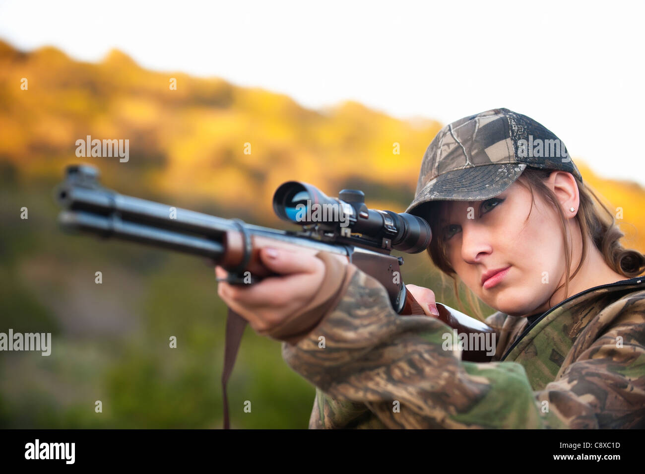 Hunting woman firing rifle gun Stock Photo Alamy