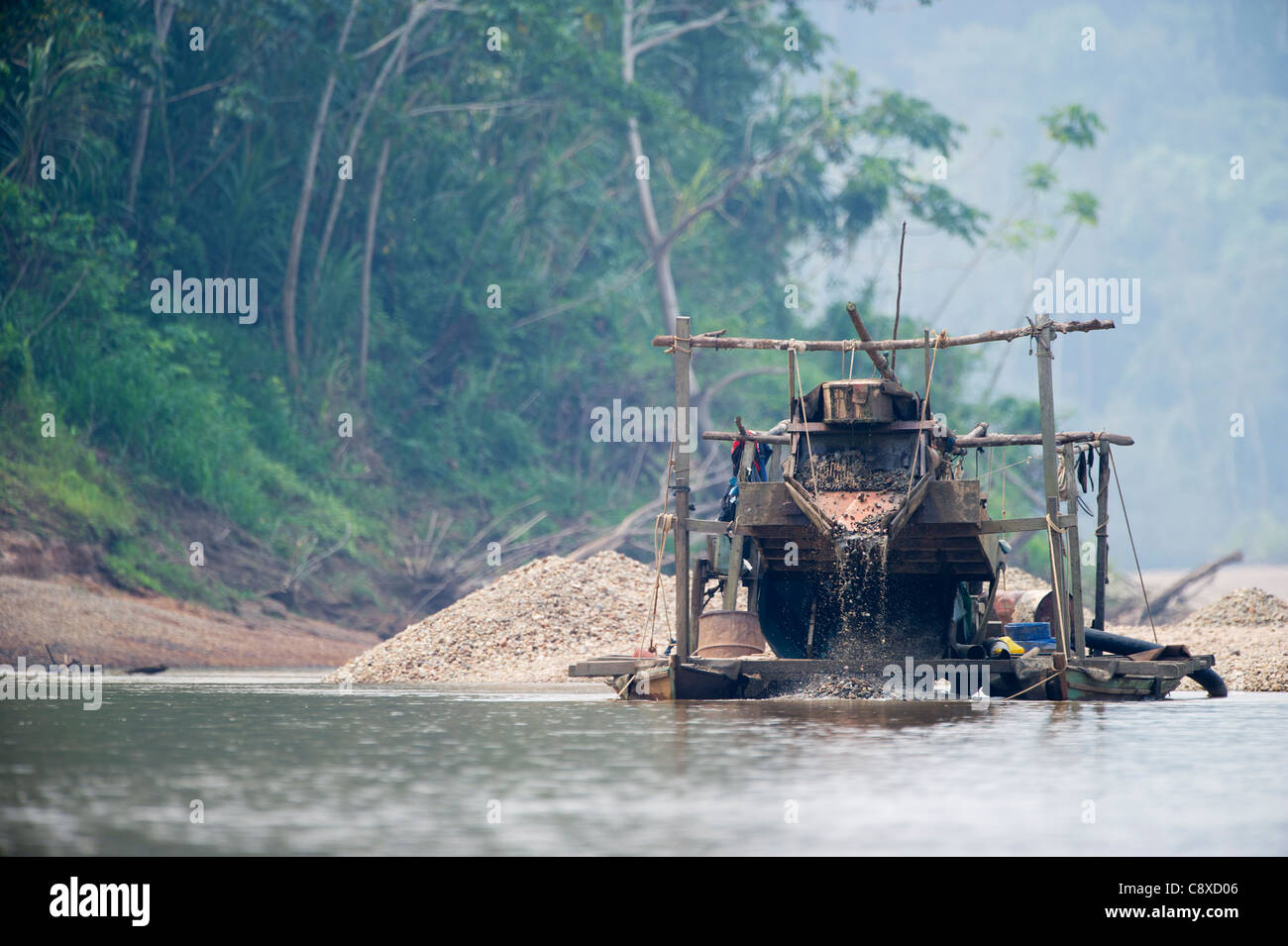 Illegal gold mining along the Madre de Dios River near Puerto Maldonado in Amazon Basin Peru Stock Photo