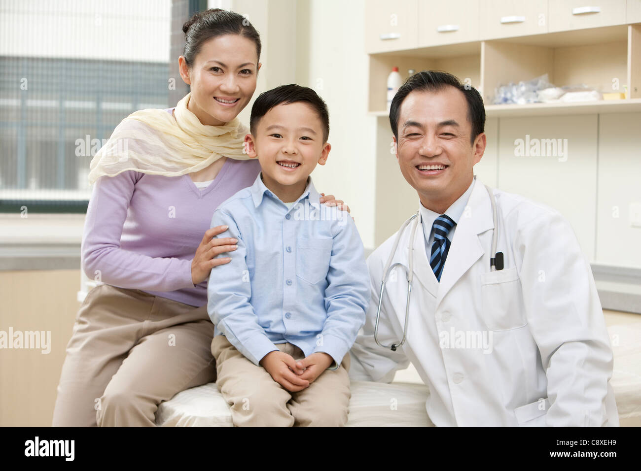 Mother and Son with Doctor in an Examination Room Stock Photo - Alamy