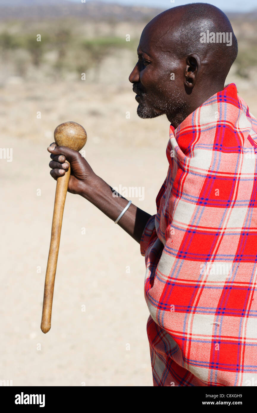 Masai elder holding a Rungu a club used for throwing to ward off hyenas and other animals Samburu Kenya Stock Photo