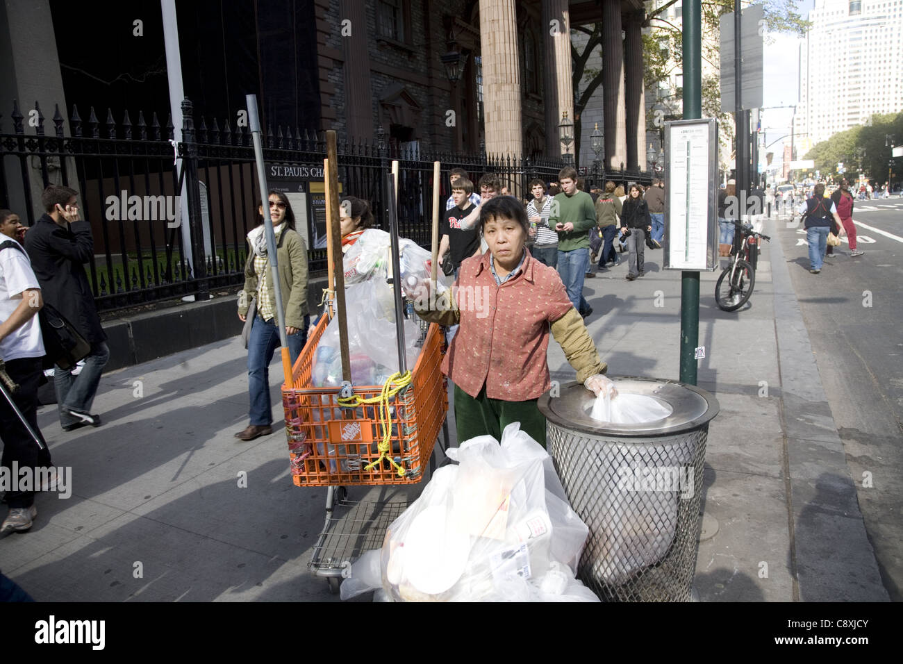 Female bottle and can collector on Broadway in the financial district
