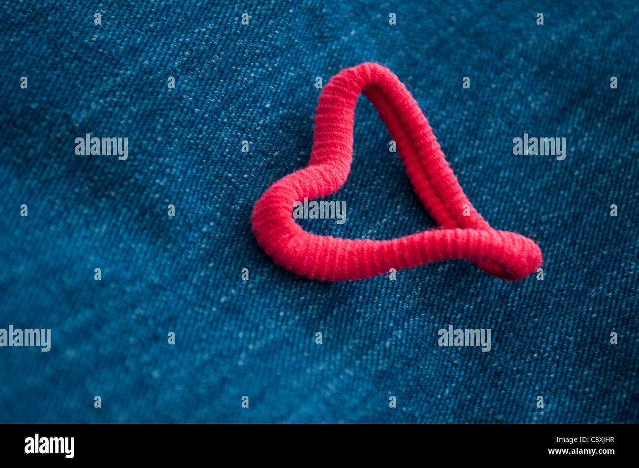 Hair elastic heart and blue jeans Stock Photo